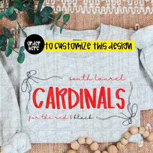 May include: A light gray sweatshirt with the words "CARDINALS" in large red letters. The text "South Laurel" and "for the red & black" are also visible. The words "order here to customize this design" are in a yellow banner.
