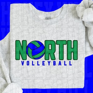 May include: A light grey sweatshirt featuring the word "NORTH" in green block letters and a blue and green volleyball graphic. The word "VOLLEYBALL" is printed in blue block letters below "NORTH".