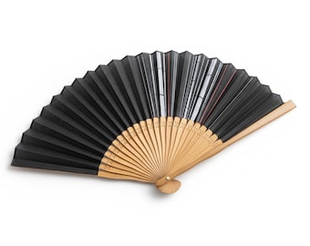 May include: A black hand fan with a natural wood handle. The fan is open, displaying its pleated design. The fan's wooden handle is made of thin, light-colored wooden slats. The fan is a traditional accessory.