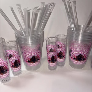 May include: Clear plastic cups and shot glasses with pink and white labels. The labels read "Yanna's 26th" and "The Sexiest Birthday" with an image of a woman. Clear plastic straws are included.