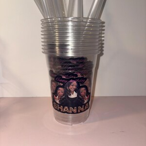May include: Clear plastic cups stacked with clear straws. The cups have a personalized design with the text "Happy Birthday" and the name "Shanna". The design features multiple images of a woman.