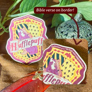 May include: Two Hufflepuff stickers with a badger illustration. The stickers have a yellow and burgundy shield design with the text "Hufflepuff" and the Bible verse "Ephesians 4:32 Be kind and compassionate".