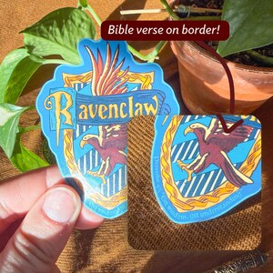 May include: Two Ravenclaw-themed stickers. One is a blue, gold, and maroon crest with the word "Ravenclaw" and a stylized eagle. The other is a similar design with the text "Get wisdom, get understanding" and a maroon eagle.