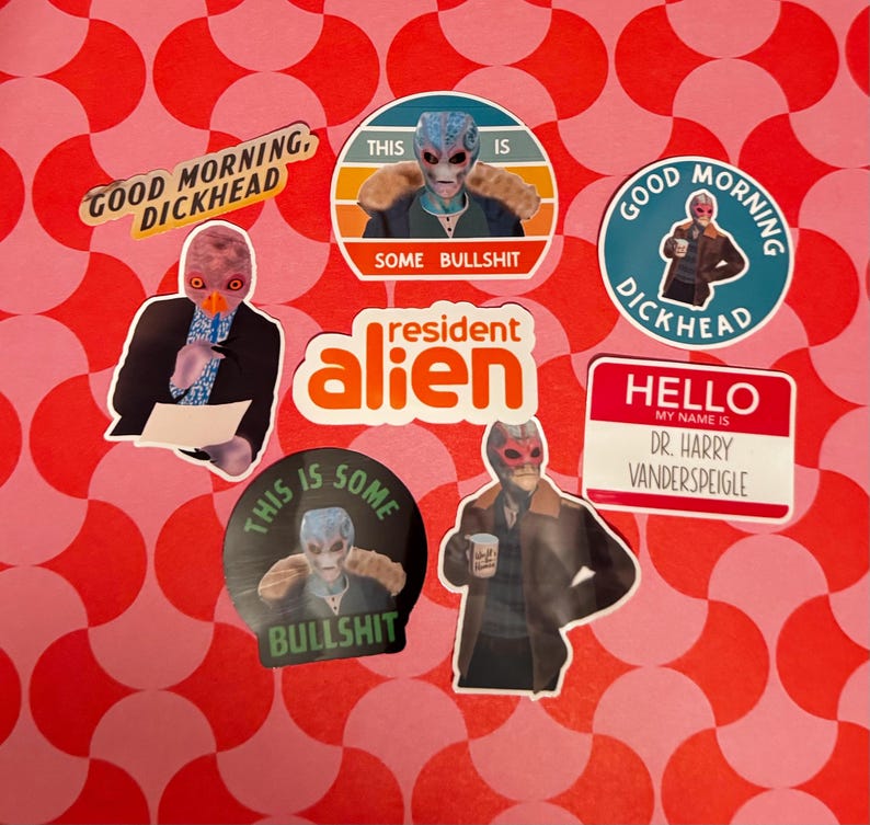 May include: A collection of stickers featuring images of an alien character in various poses. The stickers include text such as "GOOD MORNING, DICKHEAD", "THIS IS SOME BULLSHIT", and "HELLO MY NAME IS DR. HARRY VANDERSPEIGLE". The stickers are on a red and pink patterned background.