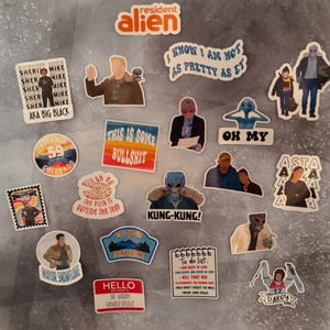 May include: A collection of colorful stickers featuring characters and phrases from the TV show Resident Alien. The stickers include images of aliens, text like "Kung-Kung!" and "This is some bullshit," and character names.