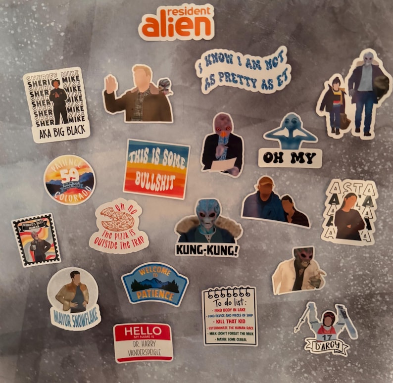 May include: A collection of colorful stickers featuring characters and phrases from the TV show Resident Alien. The stickers include images of aliens, text like "Kung-Kung!" and "This is some bullshit," and character names.