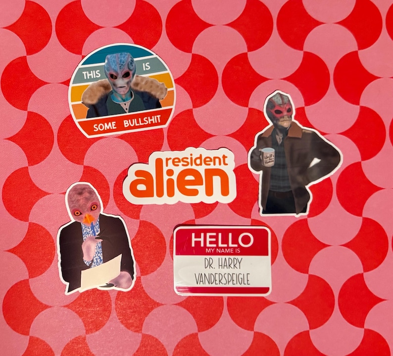 May include: A collection of stickers featuring characters and phrases from the show "Resident Alien." Stickers include an alien with the text "This is some bullshit," the show's logo, and a name tag that reads "Dr. Harry Vanderspeigle."