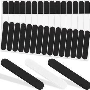 May include: A collection of black and white nail files and nail stickers. The nail files are black and white, and the nail stickers are black. The image shows the nail files and stickers on a white background.