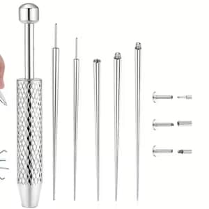 May include: A collection of silver tools, featuring a main handle with a diamond-patterned grip, various pointed probes, and small, detachable parts. These tools are likely intended for detailed work, potentially in a craft or repair setting.