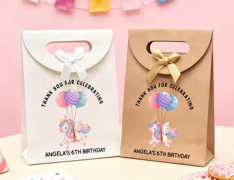 May include: Two gift bags, one white and one brown, with a handle and a bow. Each bag features a unicorn with balloons and the text "Thank you for celebrating" and "Angela's 6th Birthday."