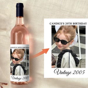 May include: A bottle of ros&eacute; wine with a dark blue cap. The label features a photo of a young person wearing sunglasses, with the text "Candice's 20th Birthday" and "Vintage 2005".