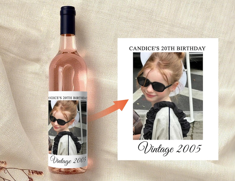 May include: A bottle of ros&eacute; wine with a dark blue cap. The label features a photo of a young person wearing sunglasses, with the text "Candice's 20th Birthday" and "Vintage 2005".