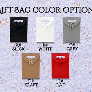 May include: Image showing five gift bag color options: black, white, grey, kraft, and red. Each bag has a handle and a ribbon. The text "GIFT BAG COLOR OPTIONS" is at the top. Each bag is labeled with a letter and color name.