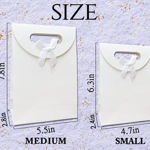May include: Two white gift bags with a handle and a white bow. The larger bag is 7.8 inches tall and 5.5 inches wide, labeled "MEDIUM". The smaller bag is 6.3 inches tall and 4.7 inches wide, labeled "SMALL". The word "SIZE" is at the top.