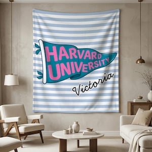 以下が含まれることがあります： 薄い青と白のストライプの背景の壁掛け。 ピンク色の「HARVARD UNIVERSITY」という文字が入ったターコイズ色のペナントが壁掛けの中央にあります。 ペナントの下には筆記体で「Victoria」という名前が書かれています。
