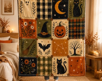 May include: A rectangular throw blanket featuring a grid of twelve squares with Halloween-themed illustrations including a ghost, a black cat, a crescent moon, a jack-o'-lantern, a witch hat, a bat, a broom, a bare tree, and floral patterns.