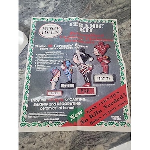 May include: A vintage Duncan Home Oven ceramic kit. The kit includes a mold, liquid clay, primer, colours, and brushes. The packaging features ceramic figurines labelled Suzy, Tim, Pop, and Mommy. The text reads "Easy Ceramics, No Kiln Needed!"