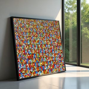 Könnte beinhalten: Ein gerahmter Kunstdruck mit einer farbenfrohen Menschenmenge. Das Kunstwerk wird von einer Vielzahl kleiner, stilisierter Figuren in einer lebendigen Farbpalette dominiert, darunter Rot, Blau, Gelb und Orange. Der schwarze Rahmen verleiht einen modernen Touch.