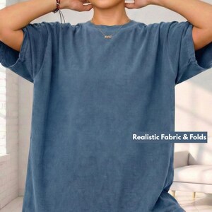 May include: A blue short-sleeved t-shirt with the text "Realistic Fabric & Folds" in white. The shirt has a relaxed fit and a slightly faded appearance. The fabric appears soft and comfortable.