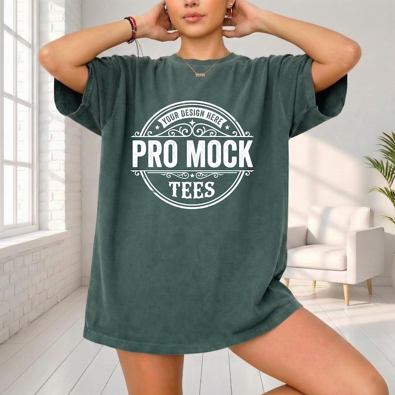 May include: A dark green oversized t-shirt with the text "YOUR DESIGN HERE" and "PRO MOCK TEES" in a white circular design. The shirt has short sleeves and a relaxed fit.
