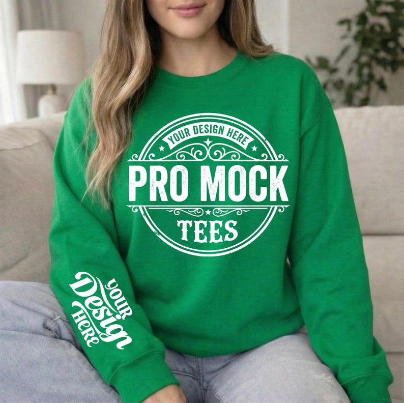 May include: A green sweatshirt with white text that reads "PRO MOCK TEES" in a circular design on the front. The sleeve has the text "YOUR DESIGN HERE". The sweatshirt is a solid green color.