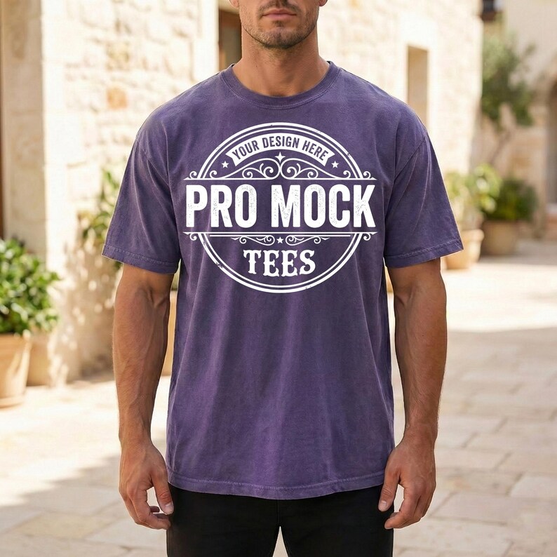 May include: A purple t-shirt with the text "PRO MOCK TEES" in a white circular design. The shirt has short sleeves and a crew neck. The text "YOUR DESIGN HERE" is above the main text.
