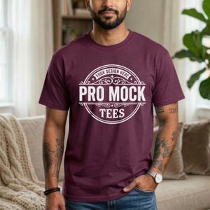 May include: A maroon t-shirt with a white circular logo that reads "YOUR DESIGN HERE" at the top, "PRO MOCK" in the center, and "TEES" at the bottom. The t-shirt is short-sleeved and has a crew neck.
