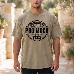 May include: A short-sleeved, olive-green t-shirt with the text "PRO MOCK TEES" in a black circular design. The shirt is a relaxed fit and has a crew neck.