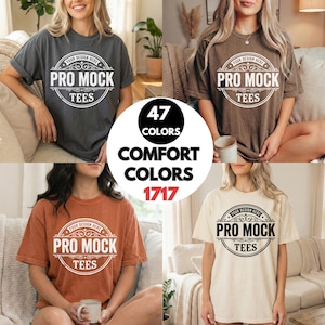 May include: Four t-shirts in different colors: charcoal, brown, rust, and cream. Each shirt has the text "YOUR DESIGN HERE PRO MOCK TEES" in a circular design. A circle in the center says "47 COLORS COMFORT COLORS 1717".