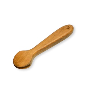 May include: A wooden spoon with a rounded head and a long handle. The spoon is made of light brown wood and has a small hole at the end of the handle. The spoon is designed for stirring and serving food.
