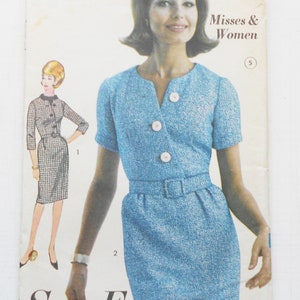May include: Vintage sewing pattern featuring a blue dress with a matching belt and large white buttons. The pattern includes a drawing of the dress and the text "Sew-Easy ADVANCE". The pattern is for Misses & Women, size 12, with a 32-inch bust.