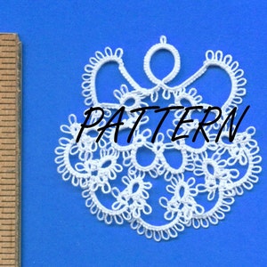 May include: White lace doily with a floral design and the word "PATTERN" in black text. The doily is on a blue background. A wooden ruler is in the image.