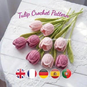 May include: A collection of handmade crochet tulips in shades of pink and purple, with green stems and leaves. The text "Tulip Crochet Pattern" is displayed above the flowers. The image includes flags of several countries.