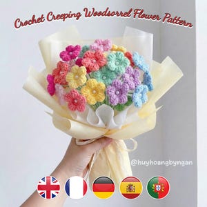 May include: A bouquet of colorful, crocheted flowers in shades of pink, red, yellow, green, purple, and blue. The flowers are wrapped in cream-colored paper and tied with a ribbon. Text at the top reads "Crochet Creeping Woodsorrel Flower Pattern".