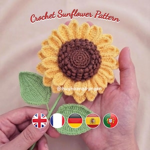 Peut inclure: Gros plan sur un tournesol crocheté avec des pétales jaunes et un centre marron. Le tournesol est accompagné de feuilles vertes et d'une tige. Le texte "Crochet Sunflower Pattern" est visible.