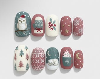 May include: A set of ten artificial nails with winter-themed designs. The nails feature illustrations of an owl, mittens, berries, snowflakes, stars, Christmas trees, a sweater pattern, a polar bear, a mug of hot chocolate, and a crescent moon.