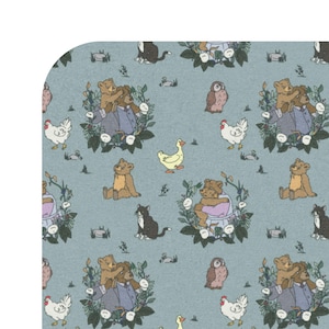 May include: A light blue fabric featuring a repeating pattern of brown teddy bears, white chickens, a yellow duck, a black and white cat, and a brown owl, all surrounded by green foliage and small white flowers in a detailed illustration style.