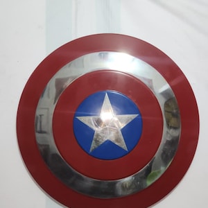 Handmade Captain America cosplay shield, a metal prop replica made from 18-gauge steel with leather and iron accents. It comes in 12, 18, 22, and 24-inch sizes. This shield is durable and features an authentic Marvel superhero design. It is ideal for comic conventions, cosplay, Avengers-themed costumes, and collector displays.
