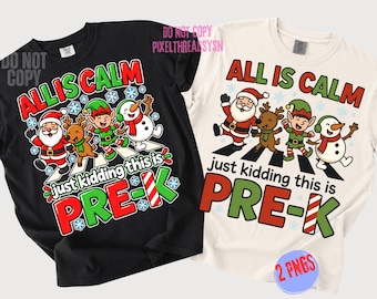 May include: A black t-shirt and a cream t-shirt, each featuring a graphic of Santa, a reindeer, an elf, and a snowman walking on a crosswalk. The text reads ALL IS CALM just kidding this is PRE-K, with the letter K styled as a candy cane.
