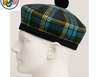 May include: A plaid beret in teal, yellow, and red, with a black pom-pom and a black ribbed band. The beret is displayed on a white mannequin head, showcasing its shape and design. This hat is a stylish accessory.