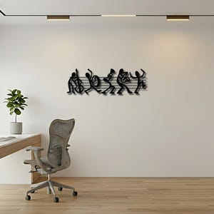 May include: A black metal wall art piece featuring a silhouette of a five-piece jazz band playing instruments. The figures are arranged in a line against a series of horizontal lines that resemble a musical staff, creating a dynamic scene.