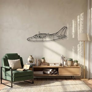 May include: A black metal airplane wall art piece. The artwork is a wireframe outline of a small airplane, mounted on a light-colored wall. The airplane is in a living room setting with a green armchair, wooden cabinet, and a floor lamp.