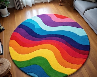 May include: A round rug with a vibrant rainbow design. The rug features wavy stripes in shades of red, orange, yellow, green, blue, indigo, and violet. The rug is placed on a wooden floor.