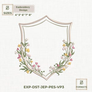May include: An embroidery design featuring a shield-shaped frame with floral accents. The design includes flowers in yellow, pink, and white, with green leaves. The design is available in 5 sizes: 4", 5", 6", 7", and 8". The design is available in 5 formats.
