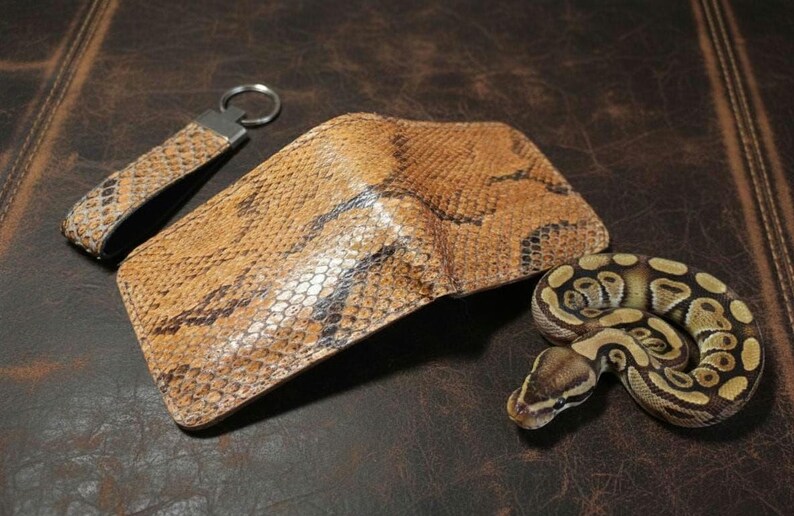 leather wallet showcasing a natural scale-like texture in earthy tones on a dark background."