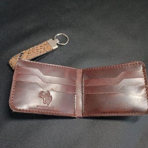 Rustic Textured Leather Wallet: "Rustic style bifold wallet for men featuring a distinctive patterned exterior and smooth leather pockets."