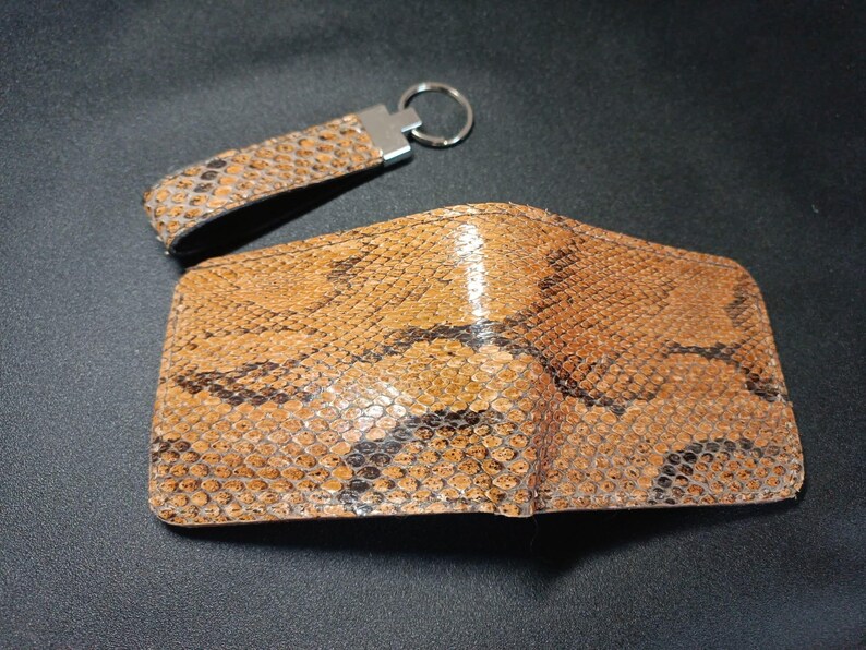 Embossed Leather Accessory Set: "A set of premium leather goods including a textured bifold wallet and a durable metal ring keychain."