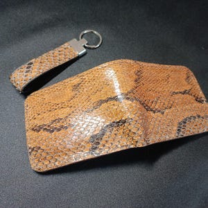 Handmade Brown Bifold Wallet: "Open brown leather bifold with multiple card slots and an embossed professional logo."