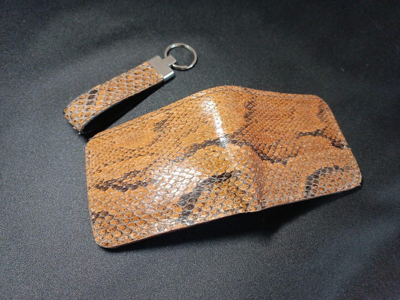 Handmade Brown Bifold Wallet: "Open brown leather bifold with multiple card slots and an embossed professional logo."