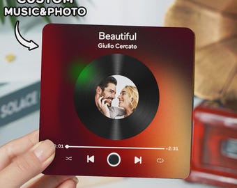 May include: A square, personalized music and photo gift with a gradient red and yellow background. The design features a vinyl record graphic with a couple's photo, the song title "Beautiful" and artist name. The text "CUSTOM MUSIC & PHOTO" is also visible.